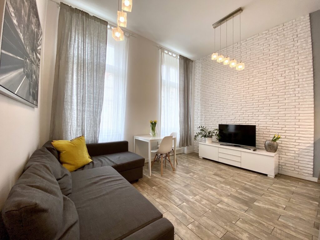 wrocław apartament aravel monte bianco duży salon biala cegła na ścianie